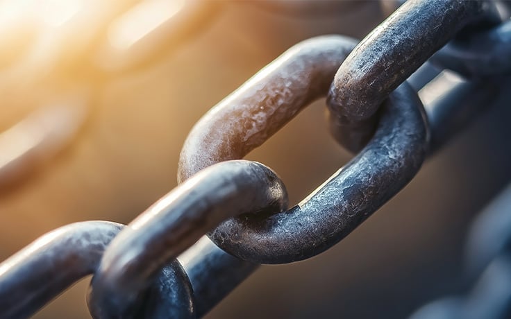 A close-up of interlocking metal chains, representing strength.